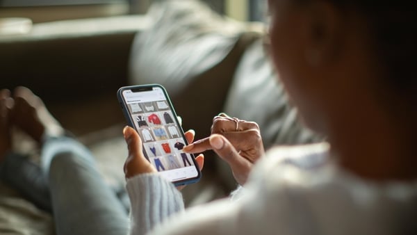 woman shopping for clothes on her smart phone