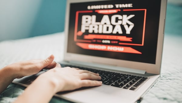 Image shows a oman at home shopping online on laptop for Black friday sales