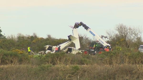 Machinery removes a plane from a crash site in Waterford