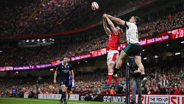 22 February 2025; James Lowe of Ireland out jumps Blair Murray of Wales to keep the ball in play, and assist his side's second try scored by teammate Jamie Osborne, not pictured, during the Guinness Six Nations Rugby Championship match between Wales and I