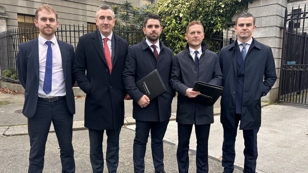 Solicitors Gavin Booth and Darragh Mackin with their legal team outside the High Court