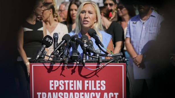 Marjorie Taylor Greene speaking at a podium 