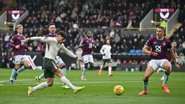 Chelsea's Portuguese midfielder #07 Pedro Neto (L) takes a shot during the English Premier League football match between Burnley and Chelsea at Turf Moor in Burnley