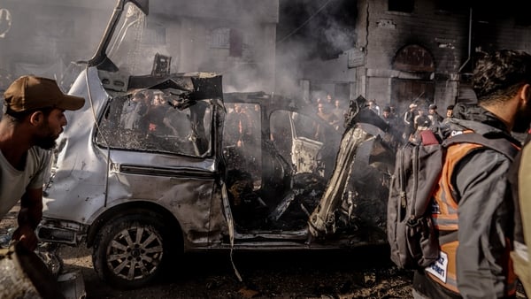 GAZA CITY, GAZA - NOVEMBER 22: A view of the site as Palestinians try to inspect and rescue the dead bodies of victims from a burning vehicle after Israeli forces bombed a vehicle in the al-Abbas area in western Gaza despite the ceasefire, killing four Pa