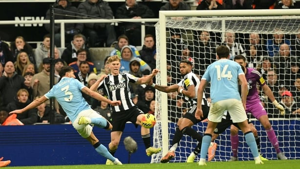 Manchester City's Portuguese defender #03 Ruben Dias (L) scores their first goal during the English Premier League football match between Newcastle United and Manchester City at St James' Park in Newcastle-upon-Tyne, north east England on November 22, 2025. (Photo by Oli SCARFF / AFP) / RESTRICTED T