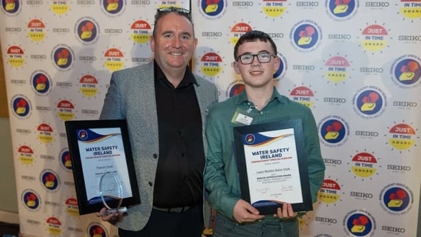 Logan Smyth (right) and his coach Padraic Dolan receiving Water Safety Ireland awards