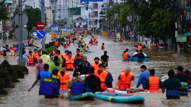 People use boats to get through flood water