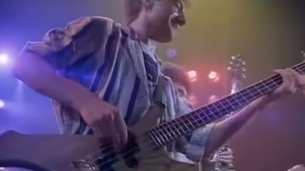 John Deacon playing the bass in the Friends Will Be Friends video