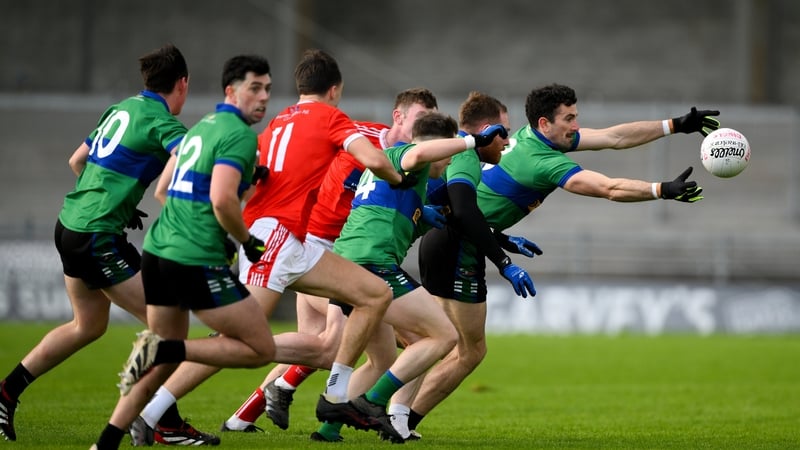 Daingean Uí Chúis's Mark O'Connor (R) emerges with the ball at Austin Stack Park