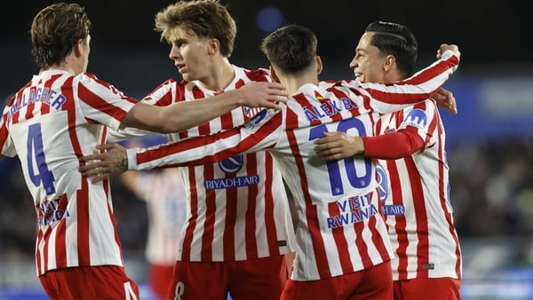 Atletico Madrid players celebrate Getafe's Portuguese defender #22 Domingos Duarte's own goal