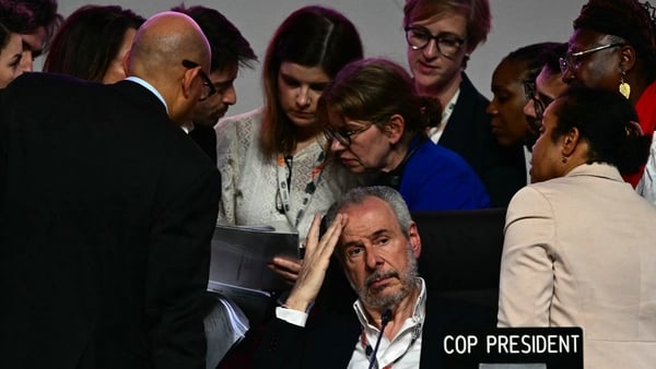 COP30 President Andre Correa do Lago (centre) gestures next to his advisers after the plenary session was interrupted