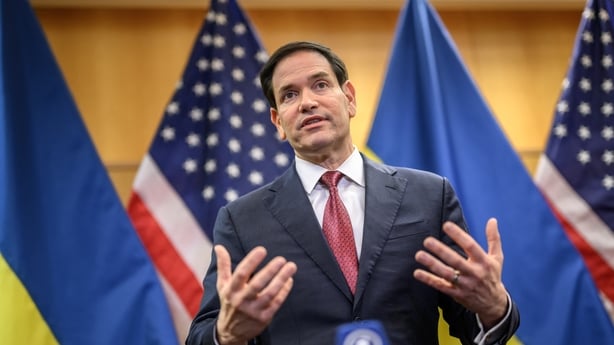 A man speaks to reporters during a press conference