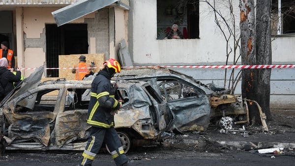 KHARKIV, UKRAINE - NOVEMBER 19: A rescuer walks past wreckage of cars near damaged residential building after Russian drone attack on November 19, 2025 in Kharkiv, Ukraine. 32 People were wounded, including children. Six of the wounded were hospitalized.