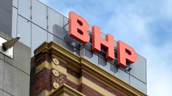 BHP Group logo on the top of a building with a blue sky in the background