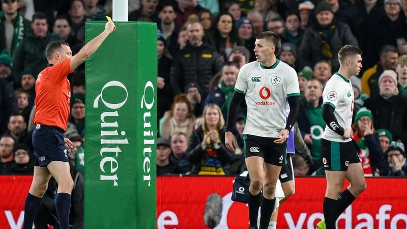 Referee Matthew Carley shows a yellow card to Ireland out-half Sam Prendergast