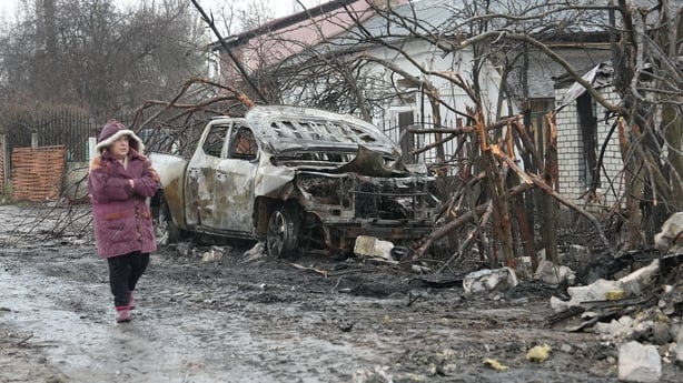 KHARKIV, UKRAINE - NOVEMBER 24: A local woman walks along a street in a private residential area in the Shevchenkivskyi district, next to houses damaged by a Russian drone strike on November 24, 2025 in Kharkiv, Ukraine. At night, the Russian military attacked Kharkiv with drones, resulting in damag