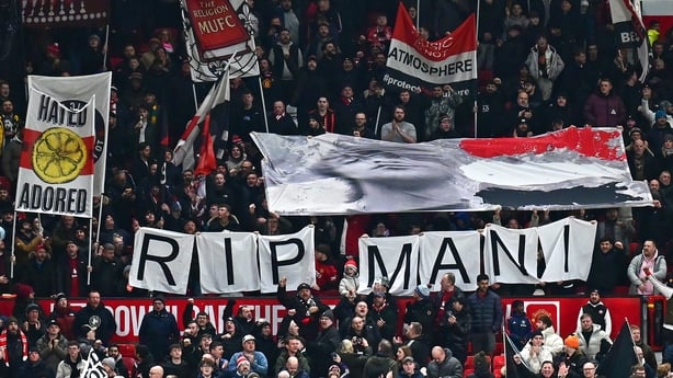 MANCHESTER, ENGLAND - NOVEMBER 24: Manchester United fans hold up a banner in honour of the late Stone Roses bass player Mani during the Premier League match between Manchester United and Everton at Old Trafford on November 24, 2025 in Manchester, United Kingdom. (Photo by Richard Martin-Roberts - C