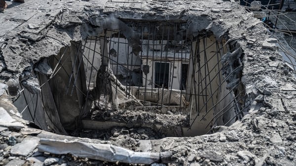 A man walks near a house damaged after an airstrike during cross-border clashes between Afghanistan and Pakistan, in Kabul on October 16, 2025