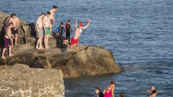 People jumping into the sea at Forty Foot during Christmas traditional swim. Dublin, Ireland. December 25, 2019