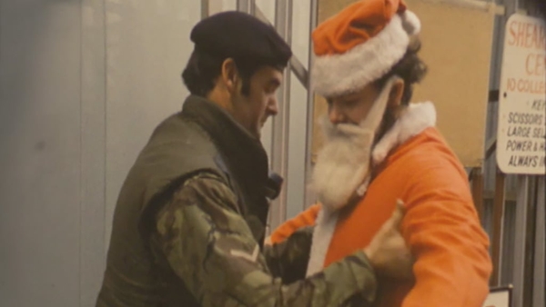 A man dressed as Santa Claus is searched by a British soldier in Belfast city centre, 1975.