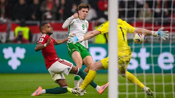 16 November 2025; Johnny Kenny of Republic of Ireland shoots at goal under pressure from Hungary goalkeeper Dénes Dibusz and Loïc Négo, left, during the FIFA World Cup 2026 Group F Qualifier match between Hungary and Republic of Ireland at Puskás Aréna in Budapest, Hungary. Photo by Stephen McCarthy