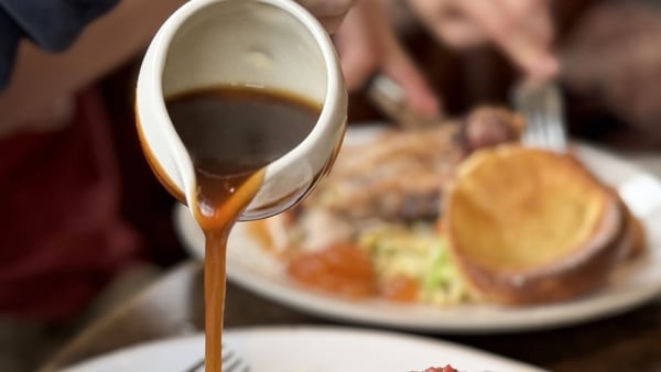 Stock photo of a traditional Sunday dinner featuring succulent roast beef, cooked to perfection and served with golden, crispy roast potatoes. Accompanied by fluffy Yorkshire puddings and a generous drizzle of rich gravy, this hearty meal is complemented