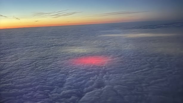 Pink light seen coming through clouds 