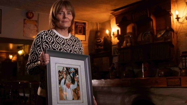 Mary Meaney holds a portrait of her father Mick