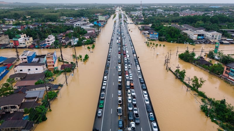 Aerial photo shows vehicles parked on an elevated road to keep them out of flood waters in Hat Yai in Thailand