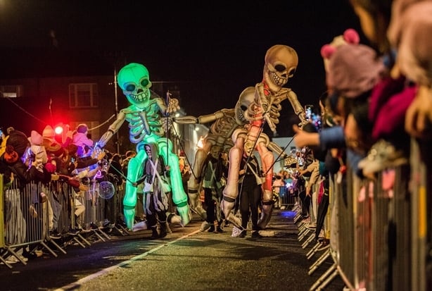 A street parade with skeleton puppets