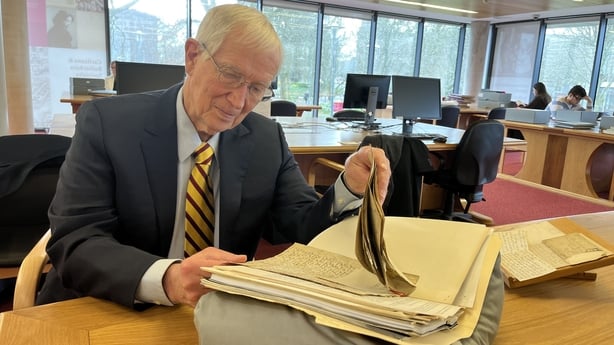 Kerby Miller pictured looking through documents