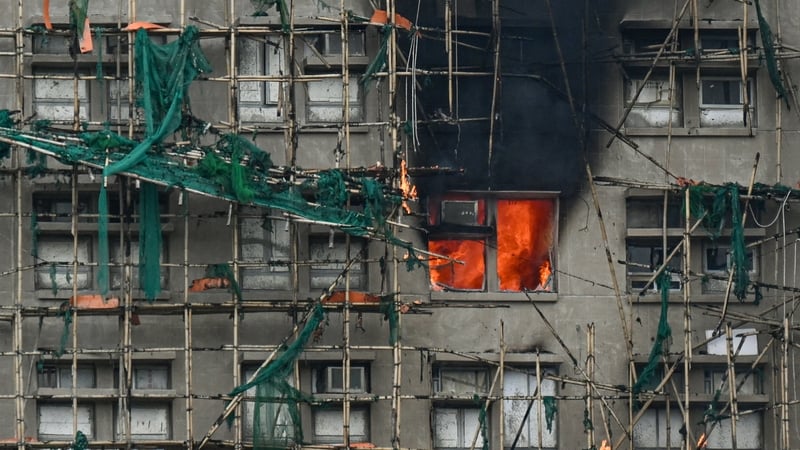 Apartments continue to burn in the Wang Fuk Court complex