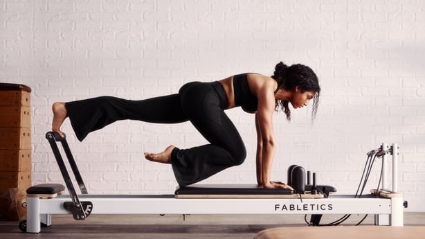 A woman doing reformer pilates