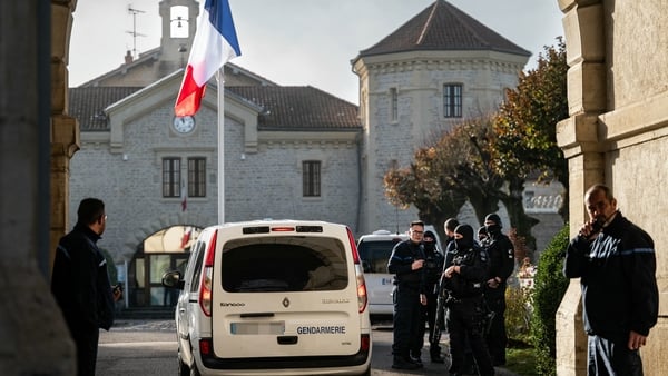 A Gendarmerie car drives past the entrance of the jail of Dijon as officers stand by