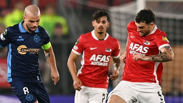 Mark Coyle of Shelbourne in action against Troy Parrott of AZ Alkmaar during the UEFA Conference League 2025/26 league phase match between AZ Alkmaar and Shelbourne at AFAS Stadion in Alkmaar, Netherlands