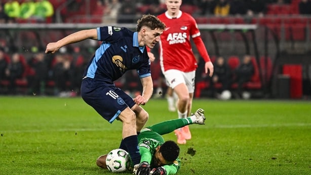John Martin of Shelbourne has a shot on goal saved by AZ Alkmaar goalkeeper Rome-Jayden Owusu-Oduroduring the UEFA Conference League 2025/26 league phase match between AZ Alkmaar and Shelbourne at AFAS Stadion in Alkmaar, Netherlands. 