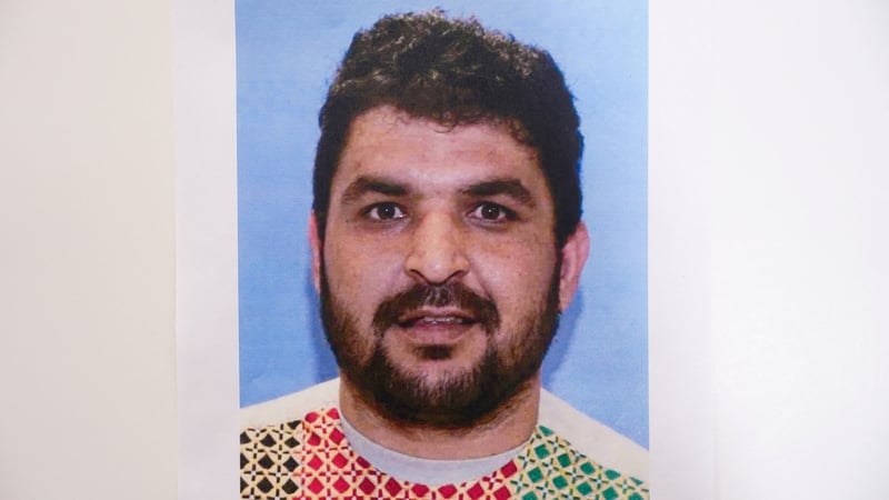 A picture of Rahmanullah Lakanwal, who is the suspect in the shooting of two National Guard members, is displayed at a press conference