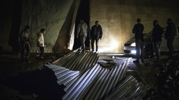 People inspect the site of a reported shooting that left two Palestinians dead in the West Bank.