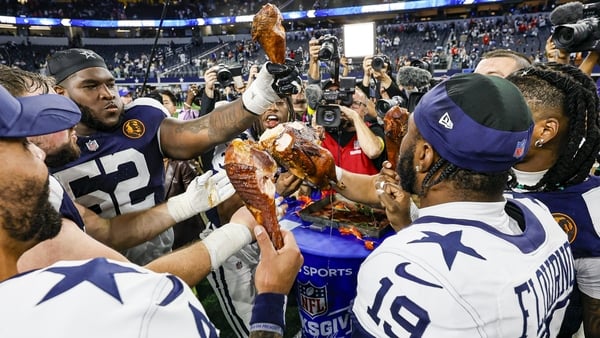 Dallas Cowboys players celebrate eating a smoked turkey after victory over the Kansas City Chiefs in Texasorter Tracy Wolfson after the game between the Dallas Cowboys and the Kansas City Chiefs on November 27, 2025 at AT&T Stadium in Arlington, Texas. (