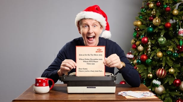 Patrick Kielty poses in a Santa hat in a promo shot for The Toy Show
