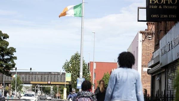 Irish tricolour flags hanging on poles on the North Strand Street in Dublin