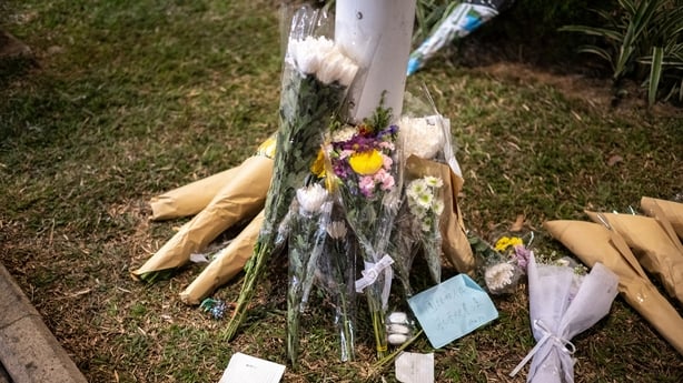 Flowers and messages are left after a fire killed 128 people