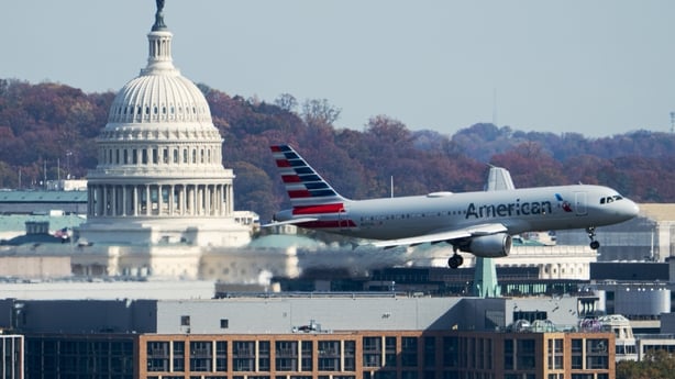 An American Airlines Airbus A320 plane passes by the US Capitol dome in Washington 