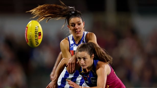 Erika O'Shea, left, challenges Ruby Svarc of the Lions for possession in the Grand Final
