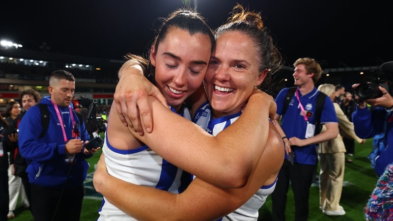 Fermanagh's Blaithín Bogue, left, celebrates Grand Final victory with North Melbourne team-mate Emma Kearney