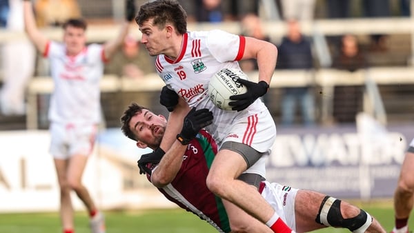 Athy's Mark Hyland gets past the challenge of Portarlington's Keith Bracken