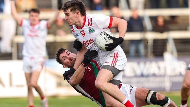Athy's Mark Hyland gets past the challenge of Portarlington's Keith Bracken