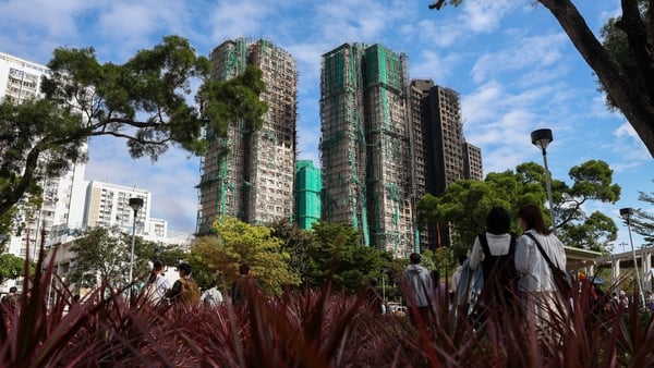 People pictured in the foreground with skyscrapers in the background