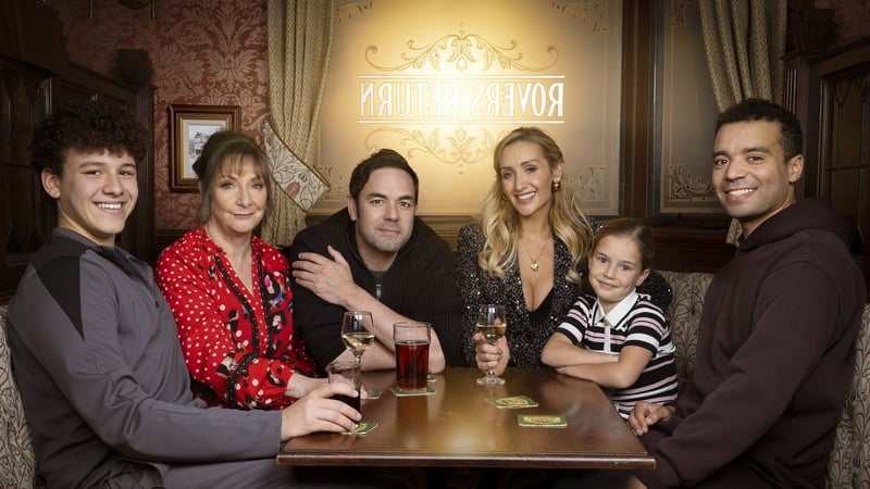 (L-R) Will Driscoll (Lucas Hodgson-Wale), Maggie Driscoll (Pauline McLynn), Ben Driscoll (Aaron McCusker), Eva Price (Catherine Tyldesley), Susie Price (Aurora Bradshaw), and Ollie Driscoll (Raphael Akuwudike) in the Rovers