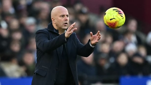 Liverpool's Dutch manager Arne Slot gathers the ball during the English Premier League football match between West Ham United and Liverpool 